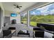 Outdoor patio with seating area, TV, and built-in grill at 6600 Dovekey Dr, Sarasota, FL 34241