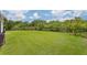Fenced-in grassy backyard providing a safe and private outdoor space at 6600 Dovekey Dr, Sarasota, FL 34241