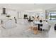 Open concept kitchen with large island, white cabinets, and marble floors at 3582 Recurve Cir, Sarasota, FL 34240