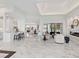 Open concept great room with marble floors, kitchen, and fireplace at 3582 Recurve Cir, Sarasota, FL 34240