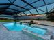 Relaxing pool and spa with covered patio overlooking lake at 3582 Recurve Cir, Sarasota, FL 34240