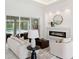 Modern living room with fireplace, large windows, and stylish furniture at 3582 Recurve Cir, Sarasota, FL 34240