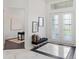 Bright entryway with marble floors, bench, and access to office at 3582 Recurve Cir, Sarasota, FL 34240