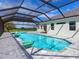 Large pool and spa with covered patio overlooking lake at 3582 Recurve Cir, Sarasota, FL 34240