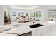 Modern kitchen with white cabinets, marble countertops, and island at 3582 Recurve Cir, Sarasota, FL 34240