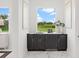 Modern wet bar with dark cabinetry, marble countertops and a window overlooking the outdoors at 3582 Recurve Cir, Sarasota, FL 34240