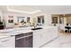 Modern kitchen features white cabinets, marble countertops, and stainless steel appliances at 3582 Recurve Cir, Sarasota, FL 34240