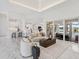 Open living room with marble floors and access to pool at 3582 Recurve Cir, Sarasota, FL 34240