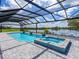 Inviting pool and spa with covered patio overlooking lake at 3582 Recurve Cir, Sarasota, FL 34240