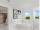 Spa-like bathroom with soaking tub, marble flooring and a walk-in closet at 3582 Recurve Cir, Sarasota, FL 34240