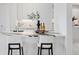 Modern kitchen island with white quartz waterfall countertop at 3582 Recurve Cir, Sarasota, FL 34240