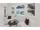 Relaxing sitting area with two armchairs and a view of the pool and lake at 3582 Recurve Cir, Sarasota, FL 34240