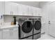 Bright laundry room with white cabinets, Samsung washer and dryer at 3582 Recurve Cir, Sarasota, FL 34240