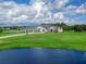 Luxury home with a lake view, a large yard, and a three-car garage at 3582 Recurve Cir, Sarasota, FL 34240