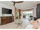 Living room with white couch, glass coffee table, and view of a lake at 5635 Spanish Point Ct, Palmetto, FL 34221