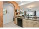 Kitchen features a breakfast bar, stainless steel sink, and beige cabinets at 5635 Spanish Point Ct, Palmetto, FL 34221