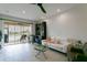Living room boasts a white couch and sliding doors that open to a lake view at 5635 Spanish Point Ct, Palmetto, FL 34221