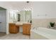 Double vanity bathroom with soaking tub and large mirror at 5635 Spanish Point Ct, Palmetto, FL 34221