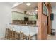 Kitchen boasts a breakfast bar with four white counter stools at 5635 Spanish Point Ct, Palmetto, FL 34221
