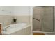 Bathroom with soaking tub and walk-in shower at 5635 Spanish Point Ct, Palmetto, FL 34221