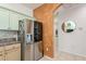 Modern kitchen with stainless steel appliances and light green cabinets at 5635 Spanish Point Ct, Palmetto, FL 34221