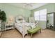 Light and airy bedroom with a queen-size bed, and herringbone floors at 5635 Spanish Point Ct, Palmetto, FL 34221