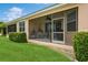 Enclosed patio with hanging chair and grill at 5635 Spanish Point Ct, Palmetto, FL 34221