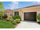 Front view of a house with a one-car garage at 5635 Spanish Point Ct, Palmetto, FL 34221