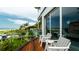 Balcony with ocean view and wooden deck at 107 Elm Ave, Anna Maria, FL 34216