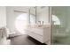 Modern bathroom with double vanity, large mirror, and walk-in shower at 107 Elm Ave, Anna Maria, FL 34216