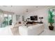 Spacious living room with white couches, large TV, and ocean view at 107 Elm Ave, Anna Maria, FL 34216