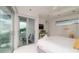 Bright bedroom with king-size bed, sliding glass doors to balcony, and ocean view at 107 Elm Ave, Anna Maria, FL 34216