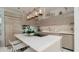 Modern kitchen with neutral cabinets, quartz countertops and stainless steel appliances at 107 Elm Ave, Anna Maria, FL 34216