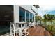 Outdoor patio area with table and chairs, overlooking the ocean at 107 Elm Ave, Anna Maria, FL 34216
