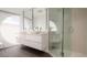 Modern bathroom with double vanity, large mirror, and walk-in shower at 107 Elm Ave, Anna Maria, FL 34216