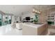 Modern kitchen with island, stainless steel appliances and white cabinets at 107 Elm Ave, Anna Maria, FL 34216