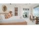 Main bedroom with ocean view, king-size bed, and en-suite bathroom at 107 Elm Ave, Anna Maria, FL 34216