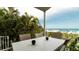 Outdoor patio with a table and chairs, offering an ocean view at 107 Elm Ave, Anna Maria, FL 34216
