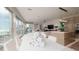 Modern dining room with ocean view and white chairs and table at 107 Elm Ave, Anna Maria, FL 34216