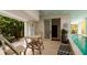 Small table and chairs near a refreshing swimming pool at 107 Elm Ave, Anna Maria, FL 34216