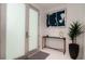 Bright and airy entryway with modern console table and art at 107 Elm Ave, Anna Maria, FL 34216