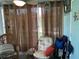 Relaxing sunroom with wicker furniture and access to outdoors at 4540 Tippecanoe Trl # 183, Sarasota, FL 34233