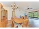 Formal dining room showcasing a chandelier, wood floors, and sliding glass doors at 1705 Curry Ave # 85, Nokomis, FL 34275