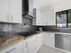 Sleek kitchen featuring gas cooktop and dark gray tile backsplash at 1886 Prospect St, Sarasota, FL 34239