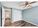 Light blue bedroom with wood floors and ceiling fan at 4300 Timberline Blvd, Venice, FL 34293