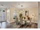 Bright dining room with hardwood floors, modern chandelier, and kitchen access at 4300 Timberline Blvd, Venice, FL 34293