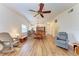 Bright living room with hardwood floors, ceiling fan, and access to a screened porch at 1705 Curry Ave # 85, Nokomis, FL 34275