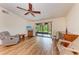 Spacious living room with wood-look floors and sliding doors to patio at 1705 Curry Ave # 85, Nokomis, FL 34275