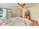Bedroom with a queen bed, wood floors, and access to a patio at 1705 Curry Ave # 85, Nokomis, FL 34275