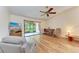 Living room with hardwood floors, ceiling fan, and screened porch view at 1705 Curry Ave # 85, Nokomis, FL 34275